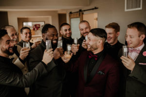 bridal party making a toast to soon to be groom